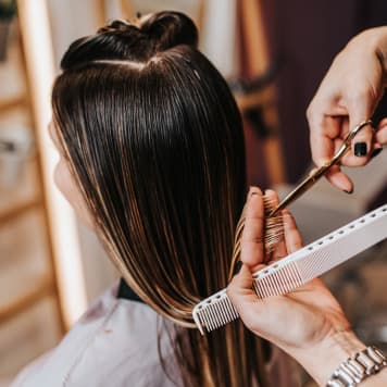 Lady having hair cut